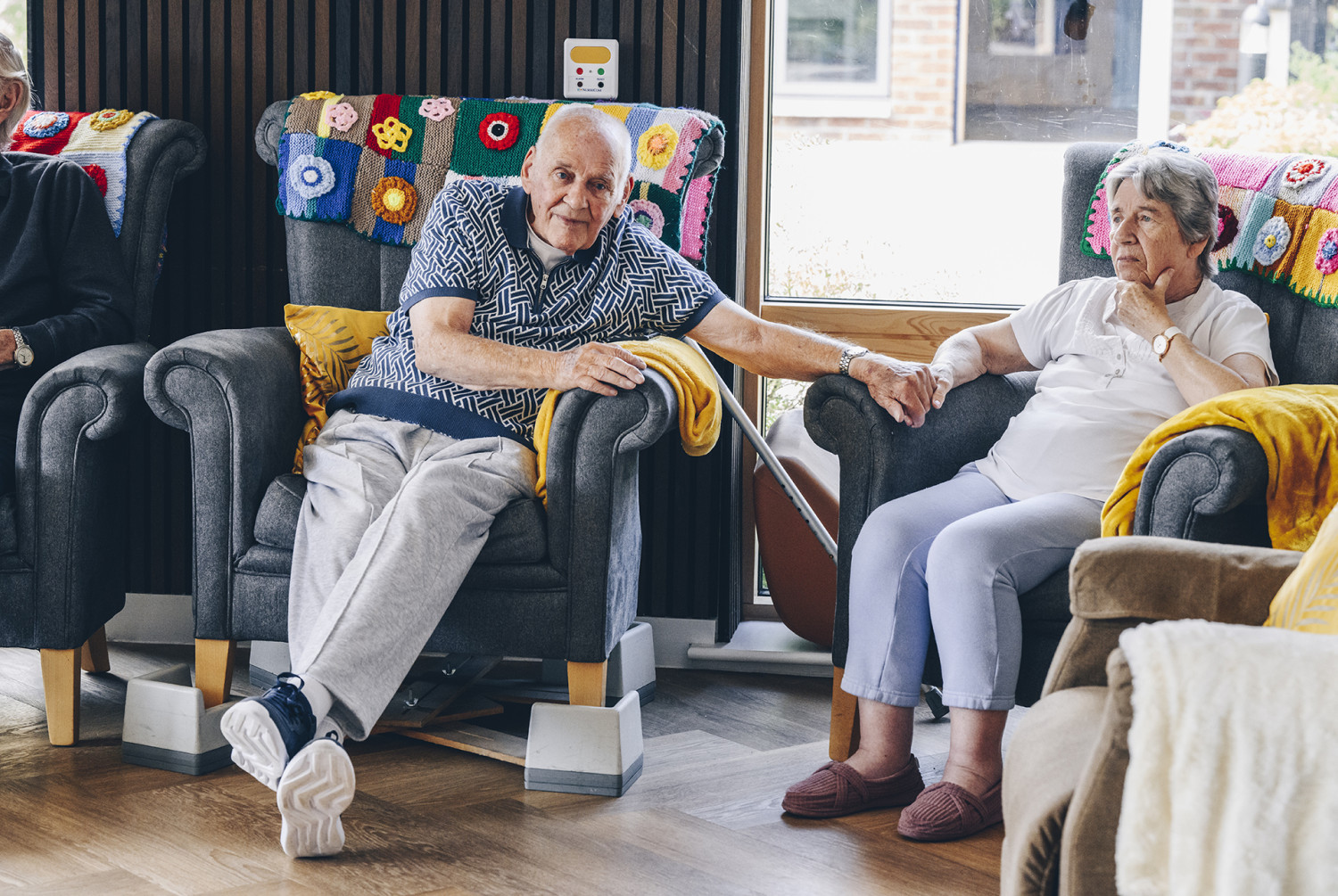 Residents in a care home holding hands